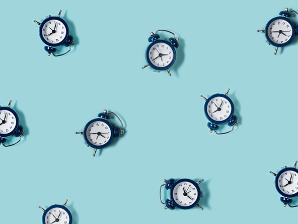 lots of round clocks against a blue background